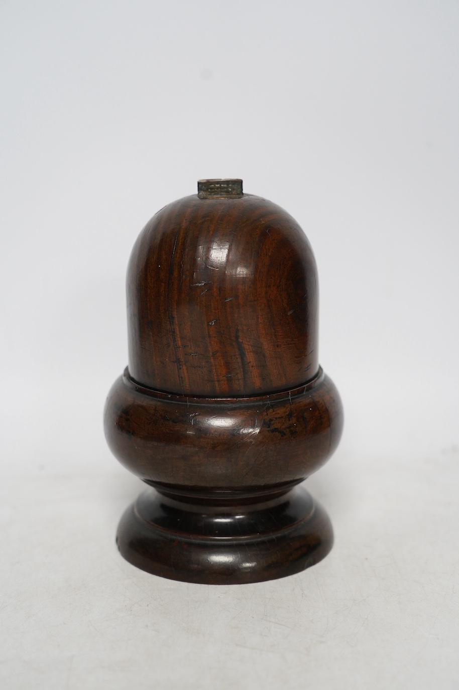 A Lignum Vitae storage vessel with a cutter / blade surmounted on the cover, possibly for cutting and storing spices, 18cm high. Condition - fair to good